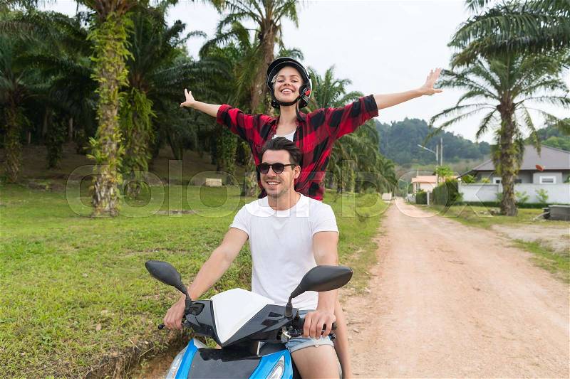Couple Riding Motorbike, Young Man And Woman Travel On Bike On Tropical Forest Road During Exotic Summer Holiday, stock photo
