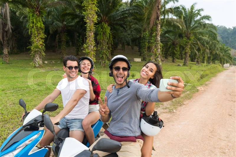 Two Couple Riding Motorbike, Man And Woman Taking Selfie Travel On Bike On Tropical Forest Road During Exotic Summer Holiday, stock photo