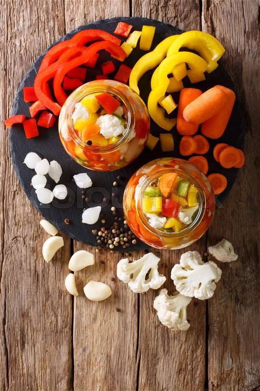 Spicy Homemade Pickled Giardiniera with Peppers, Carrots and Cauliflower. vertical view from above , stock photo