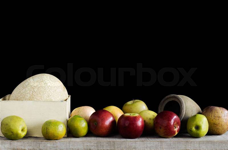 Many fruits on wooden with black background, stock photo