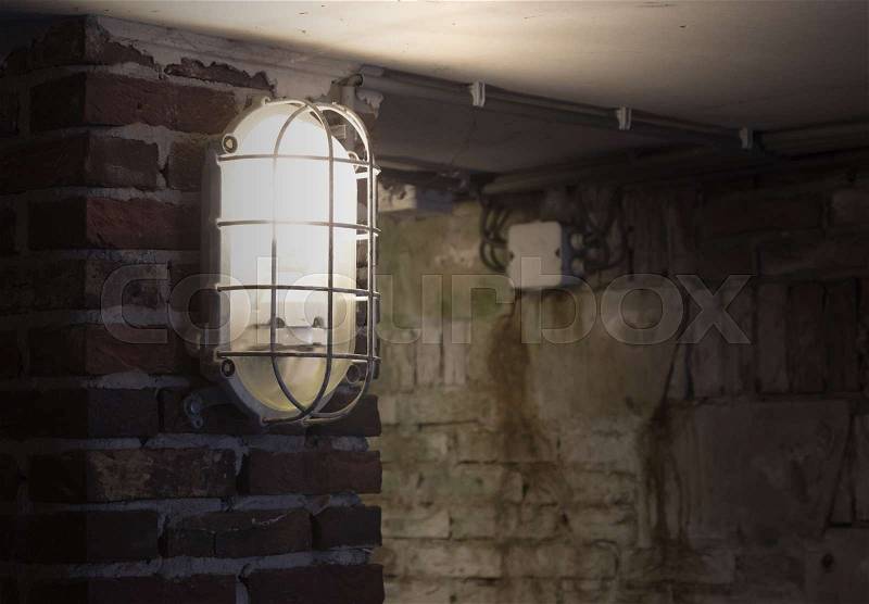 Wall light, industrial light in an old building, stock photo