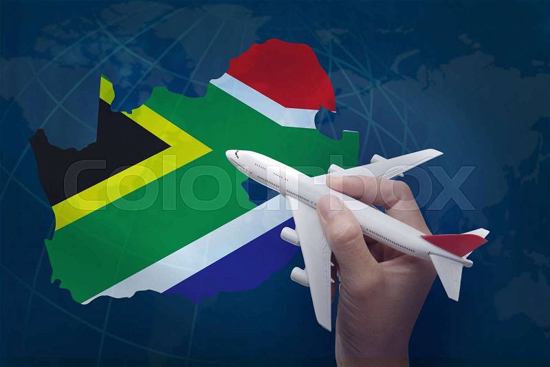Hand holding airplane with map of South Africa, stock photo
