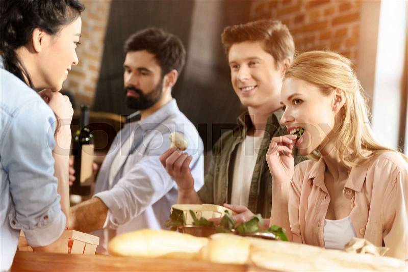 Young people having fun at home party, stock photo