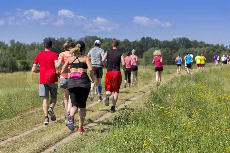 Outdoor cross-country running, Group of active people running in nature, stock photo