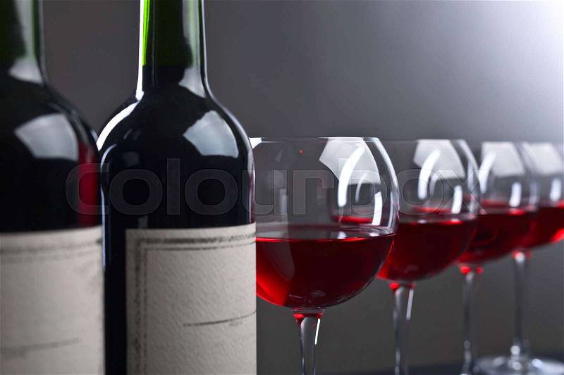 Bottle and glasses of red wine . Old paper label , stock photo
