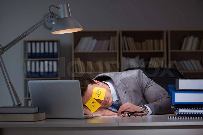 Businessman staying late to sort out priorities, stock photo