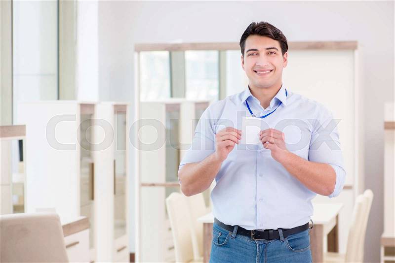 Sales assistant in furniture store, stock photo