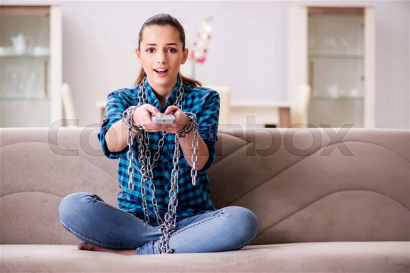 Young girl addicted to tv wasting her time, stock photo
