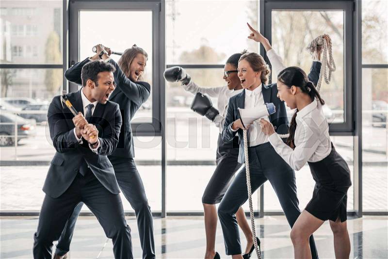 Young multicultural business teams yelling and quarreling in office , stock photo