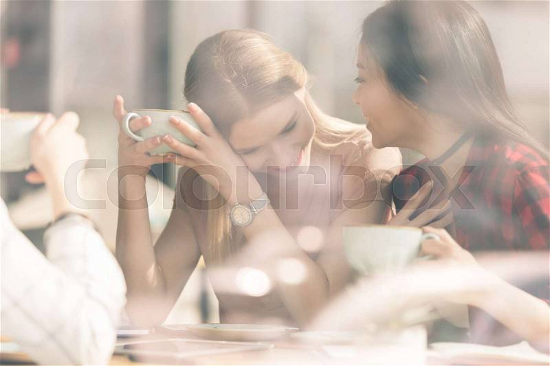 Friends spend time together on coffee break in cafe, stock photo