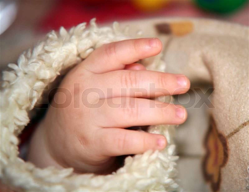 Hand of a baby in fury sleeve, stock photo
