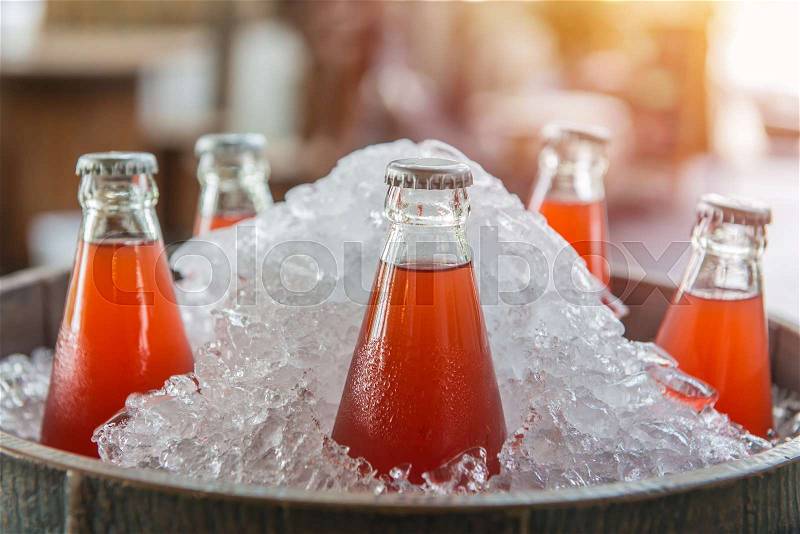 Strawberry juice bottle ice cold in the icebox, stock photo