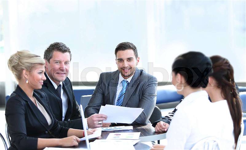 Group of young business people gathered together discussing crea, stock photo
