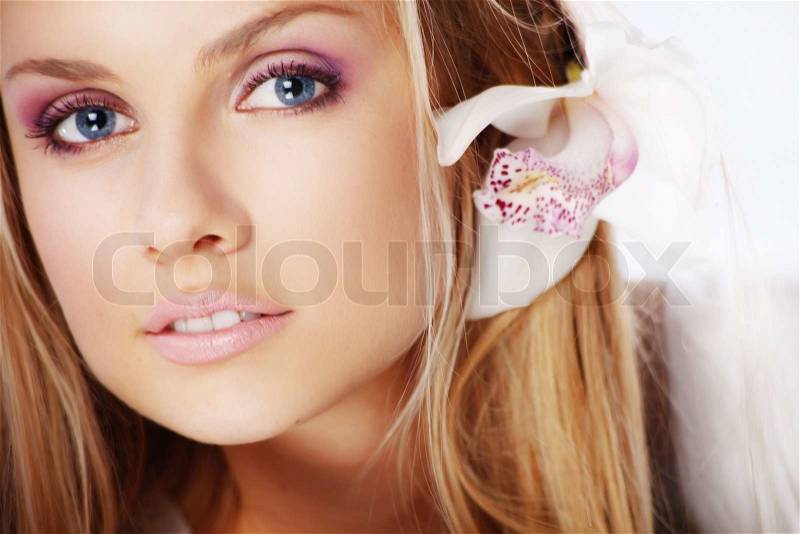 Portrait of very beautiful woman with orchid in her hair, stock photo