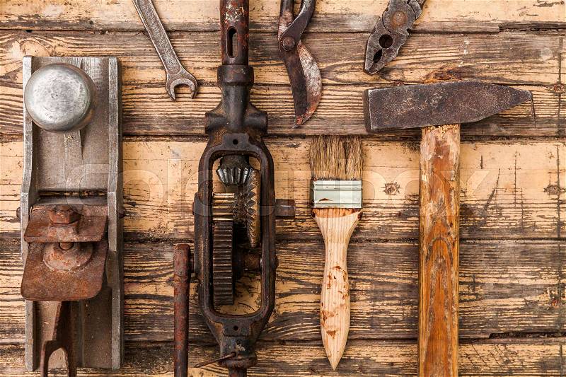 Old vintage hand tools on wooden background, stock photo