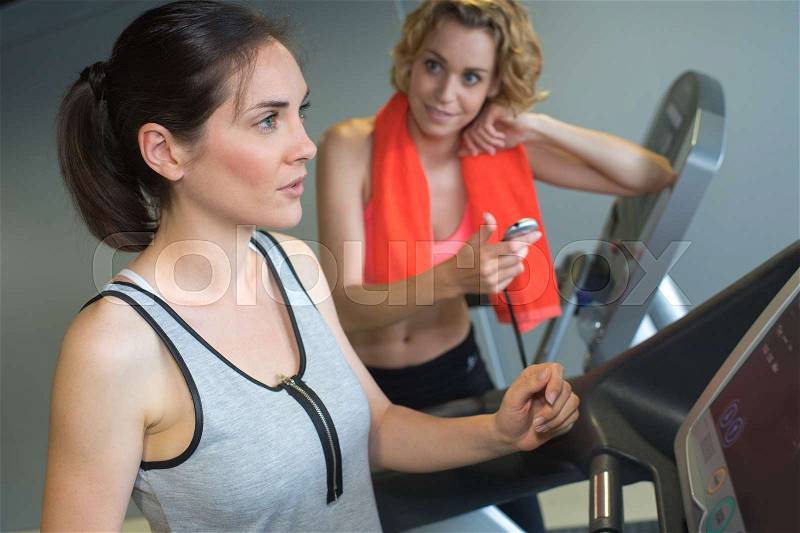 Girl exercising at the gym on stepper machine, stock photo