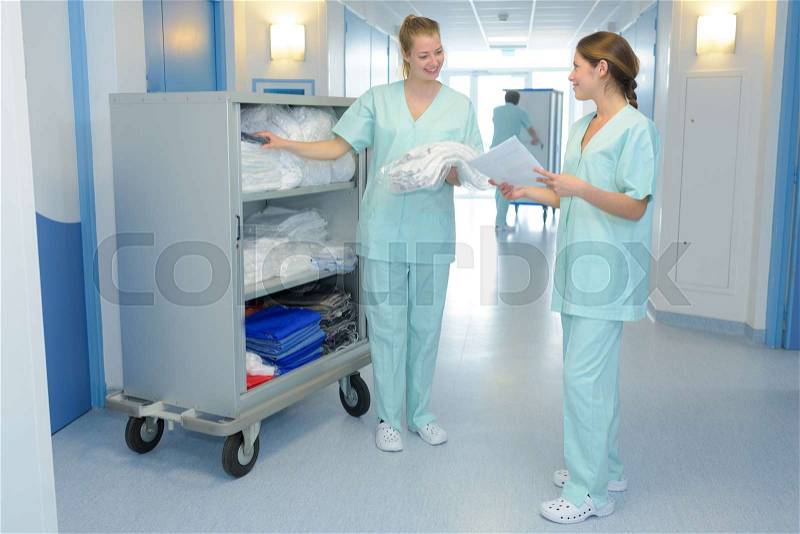 Two medical professionals talking in the hallway, stock photo