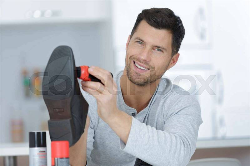 Man polish his own shoes, stock photo