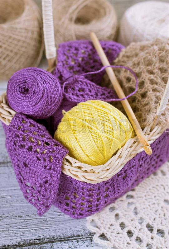 Yarn for crochet and knitted openwork napkins on shabby wooden boards, stock photo