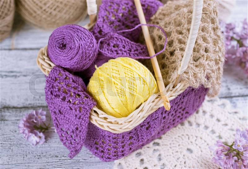 Yarn for crochet and knitted openwork napkins with lilac on shabby wooden boards, stock photo