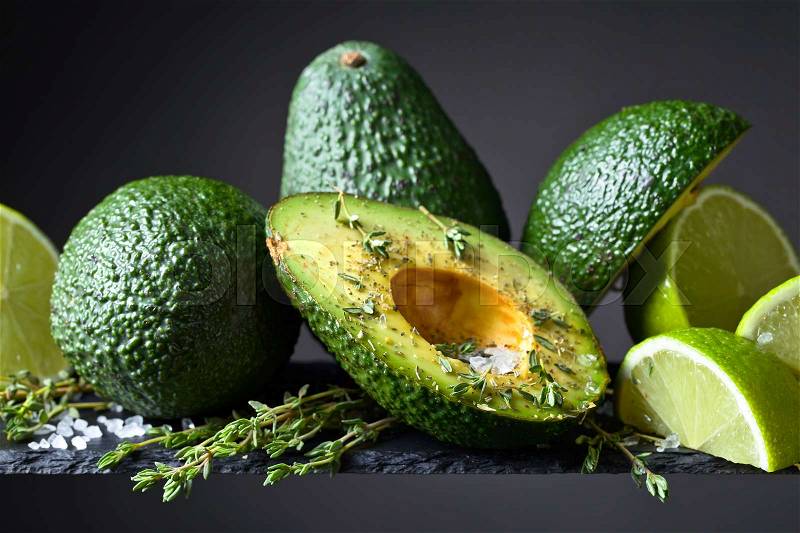 Avocado with lime , thyme and sea salt .Healthy vegetarian food , stock photo