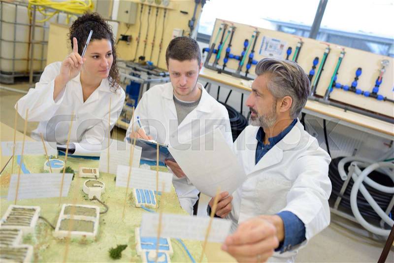 Students and teacher in class with electronic project, stock photo