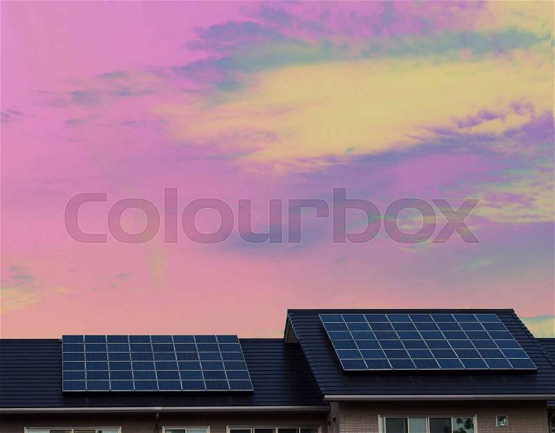 Solar panels on roof of a house with surreal color background, stock photo