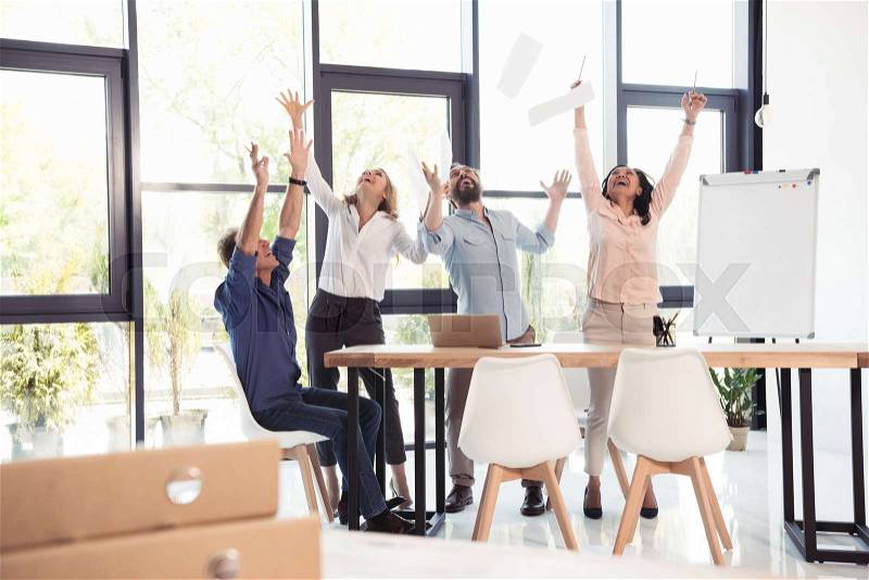Happy business team celebrating success together at office, stock photo