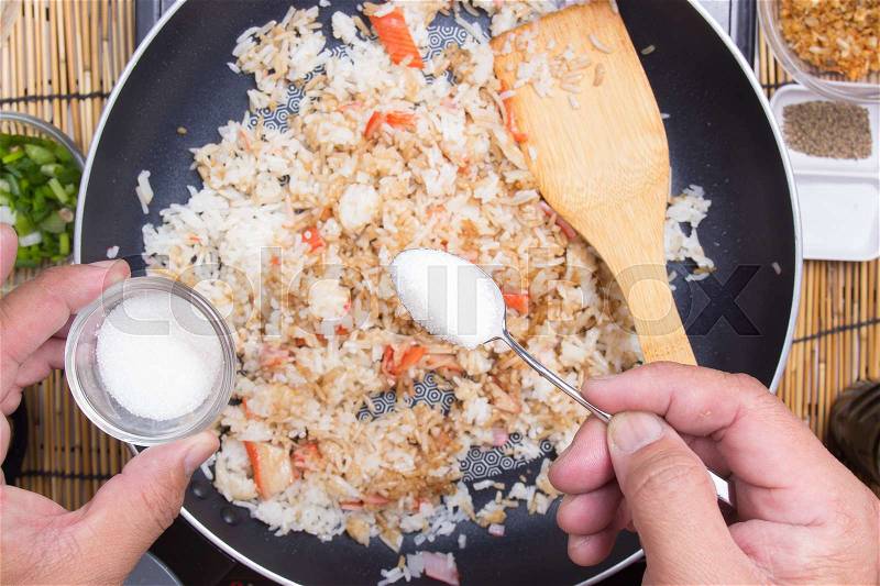 Chef putting sugar for cooking rice / cooking fired rice concept, stock photo
