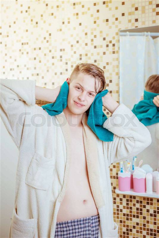 Man with a towel in the bathroom, stock photo