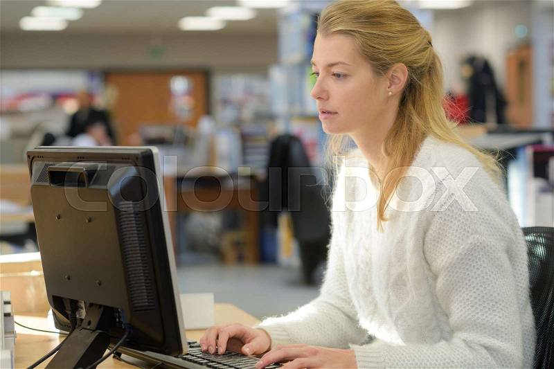 Female office worker with computer, stock photo