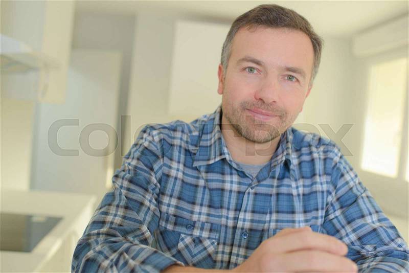 Mature man looking around vacant new property, stock photo