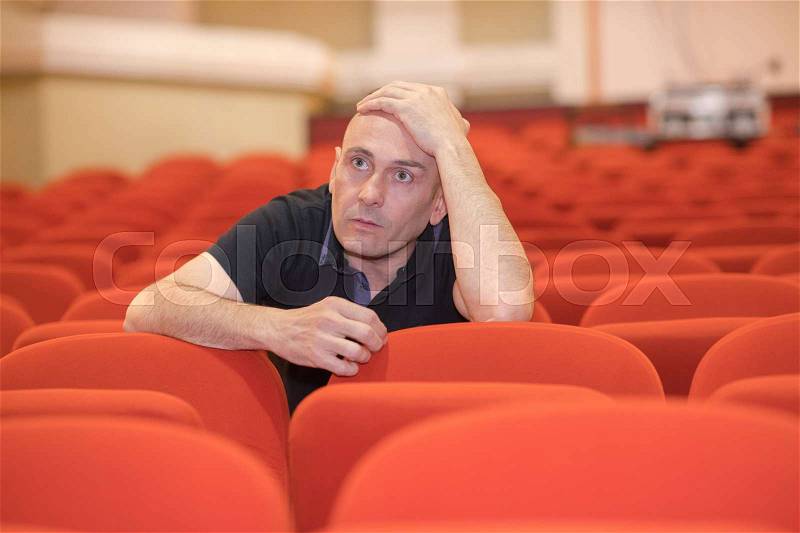 An artistic director reviewing actors in a theater, stock photo