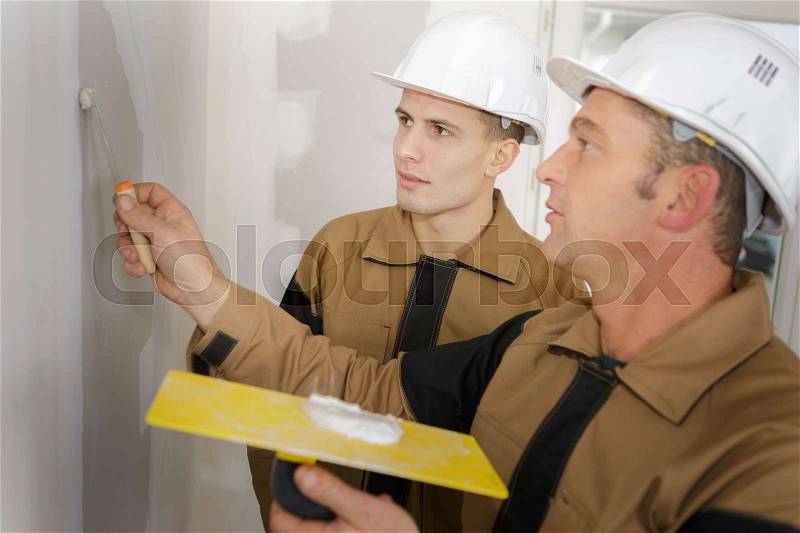 Work plasterer painter learning to make repairs, stock photo