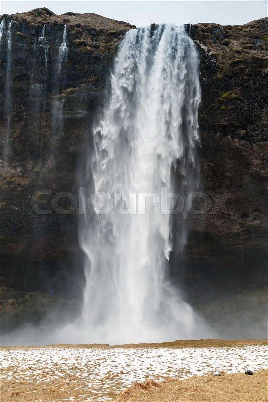 Vertical landscape of Seljalandfoss waterfall, popular natural landmark of Icelandic nature, stock photo
