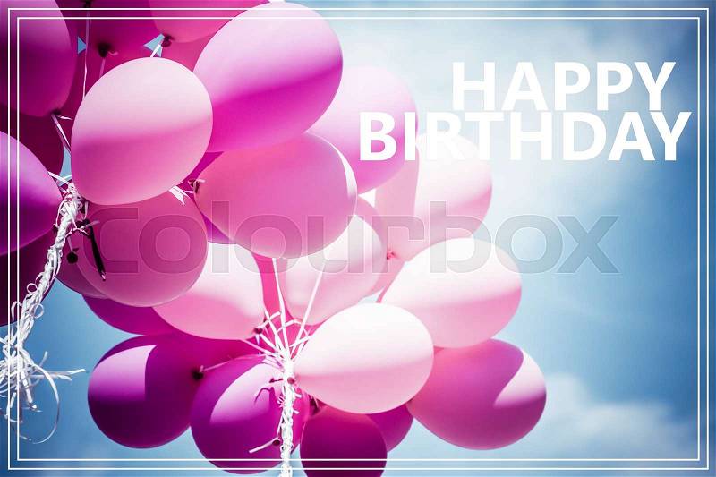Word Happy Birthday over pink balloons and blue sky background, stock photo