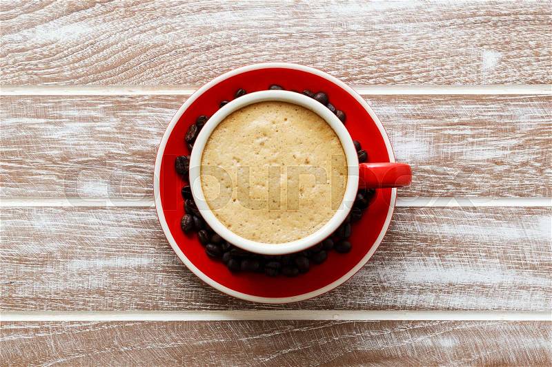 Red cup of coffee on wooden office table background top view, stock photo