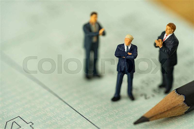 Miniature people small figure businessman standing on bank account book and others clapping as business financial concept, stock photo