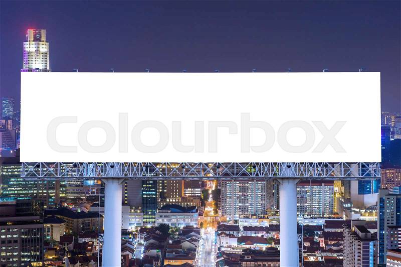 Blank billboard for advertisement in city downtown at night, stock photo