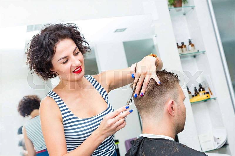 The young man at the hairdresser salon hairstyle make model, stock photo