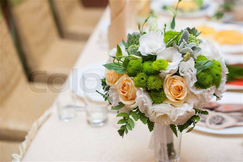 Wedding bouquet on the table in restaurant, stock photo