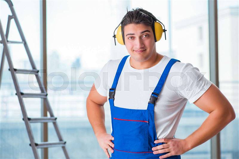 Worker with noise cancelling headphones, stock photo