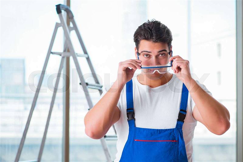 Young worker with safety goggles, stock photo