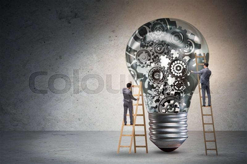 Businessman on ladder repairing light bulb, stock photo