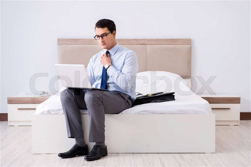 Businessman working in hotel room, stock photo