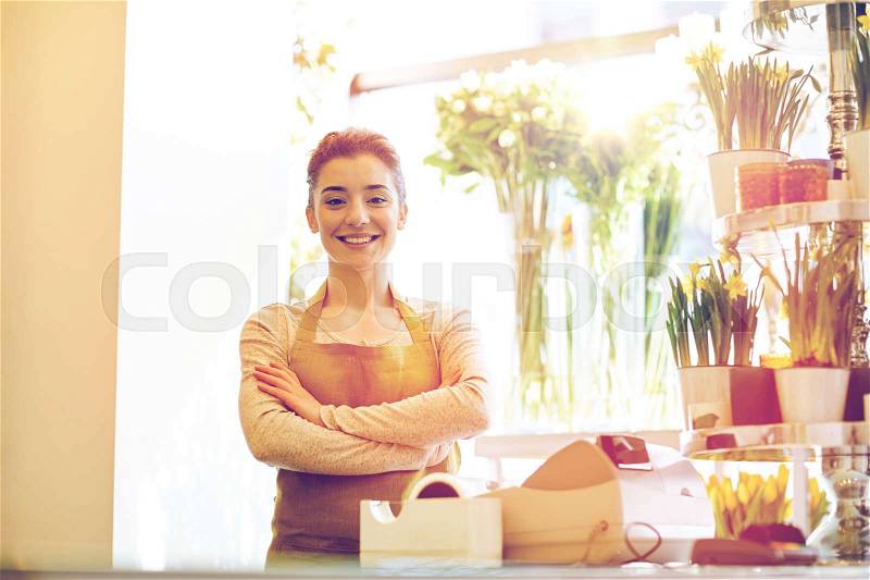 People, business, sale and floristry concept - happy smiling florist woman at flower shop cashbox, stock photo
