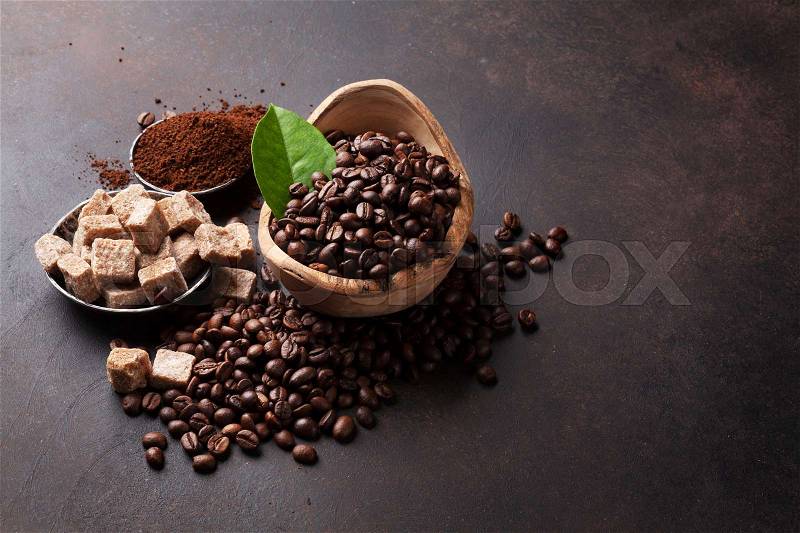 Coffee beans and ground powder on stone background. With copy space for your text, stock photo