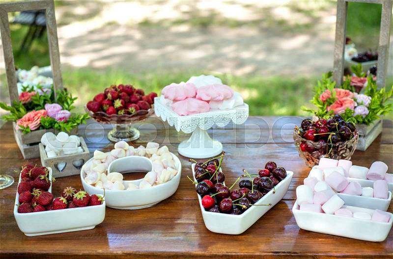 Festive table setting with fruit and marshmallows. Wedding decor, stock photo