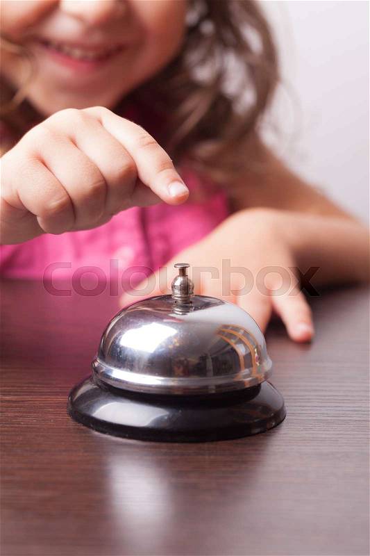 Little pretty girl push on the bell, board game on time, stock photo
