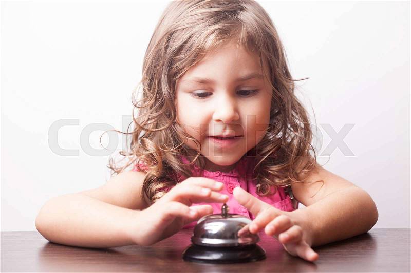 Little pretty girl push on the bell, board game on time, stock photo